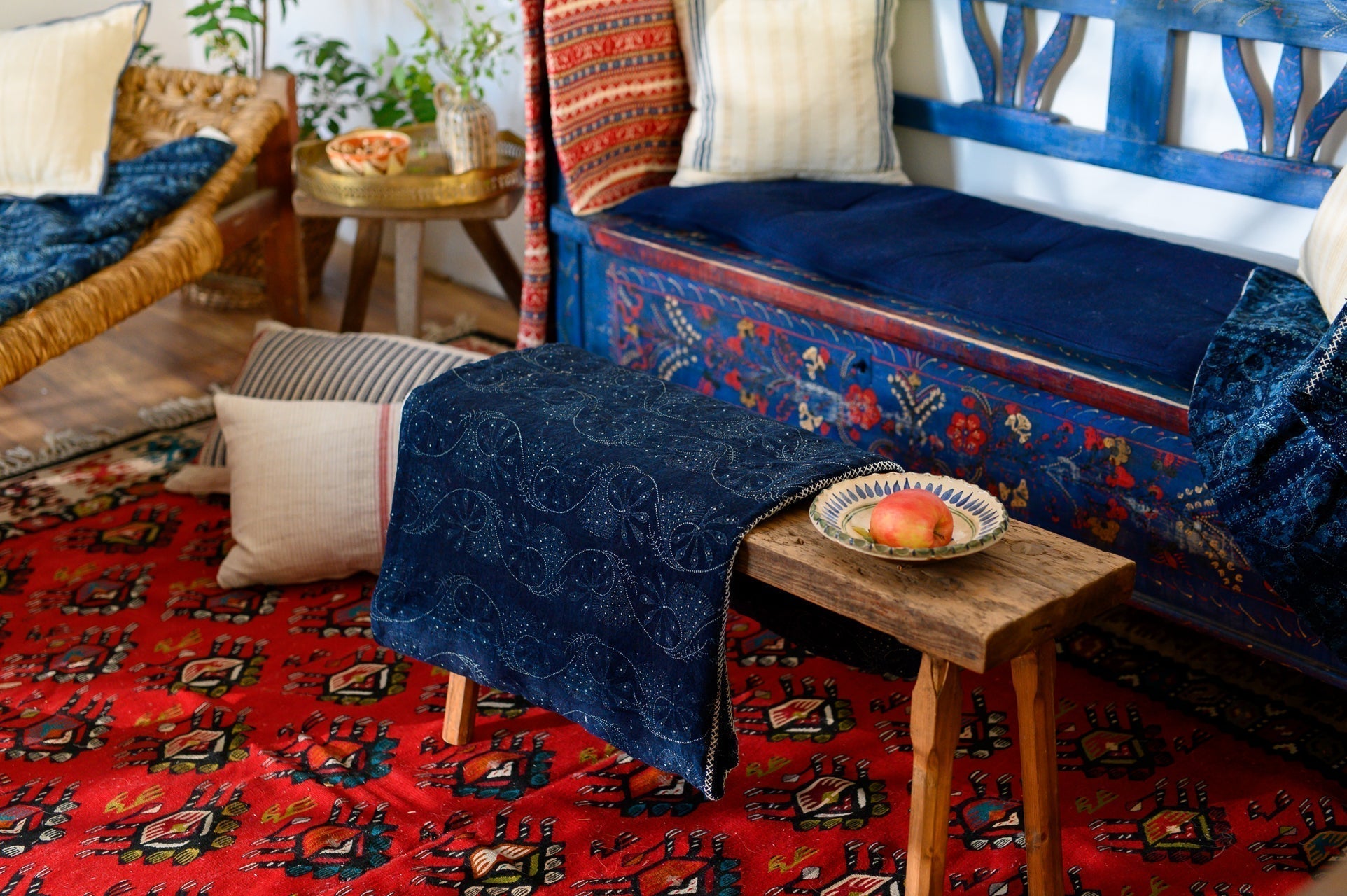 Handwoven antique hemp pillow on rustic bench in vibrant home decor setting.