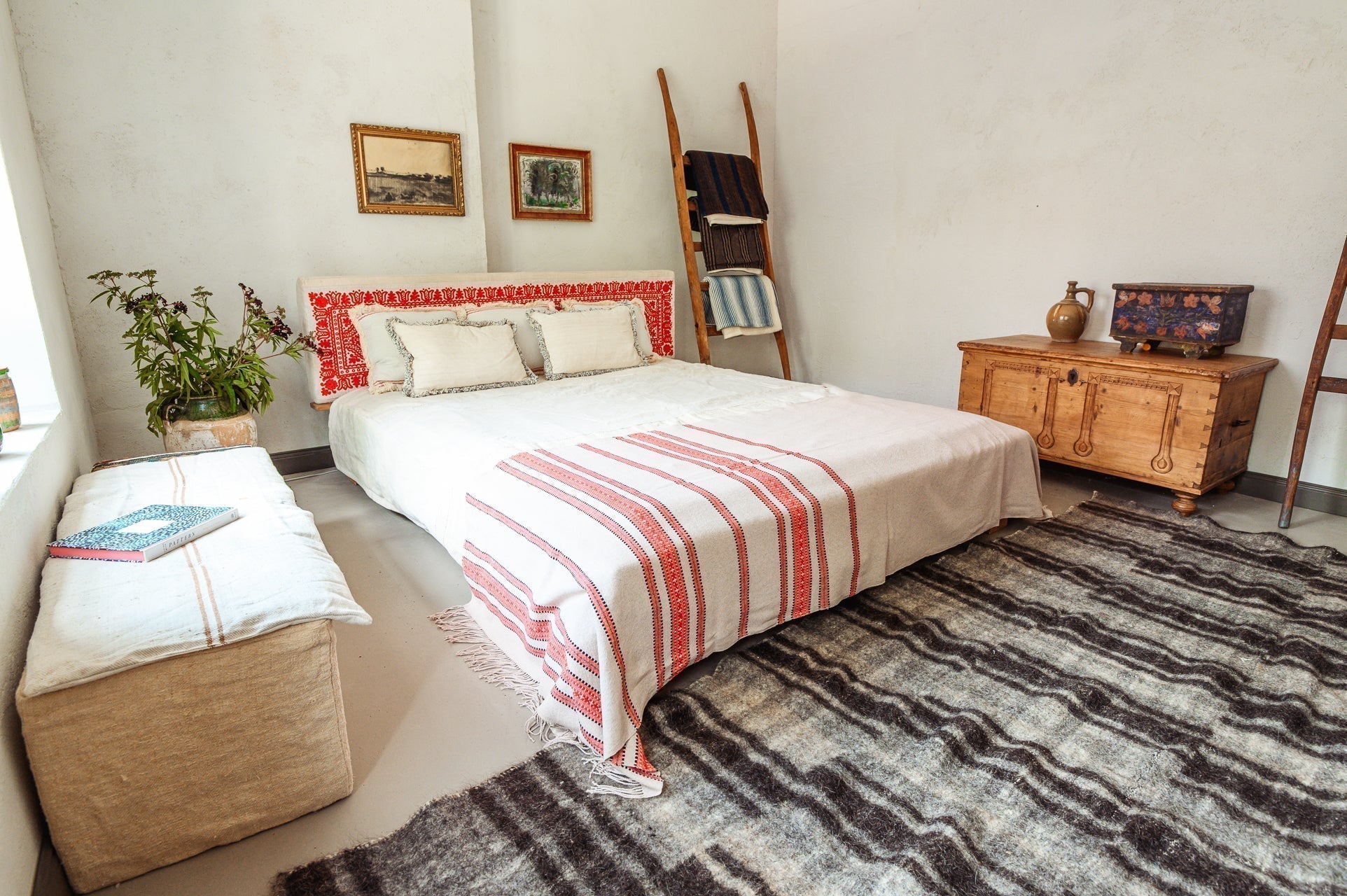 Organic handwoven hemp bed cover on a neatly arranged bed in a cozy bedroom.