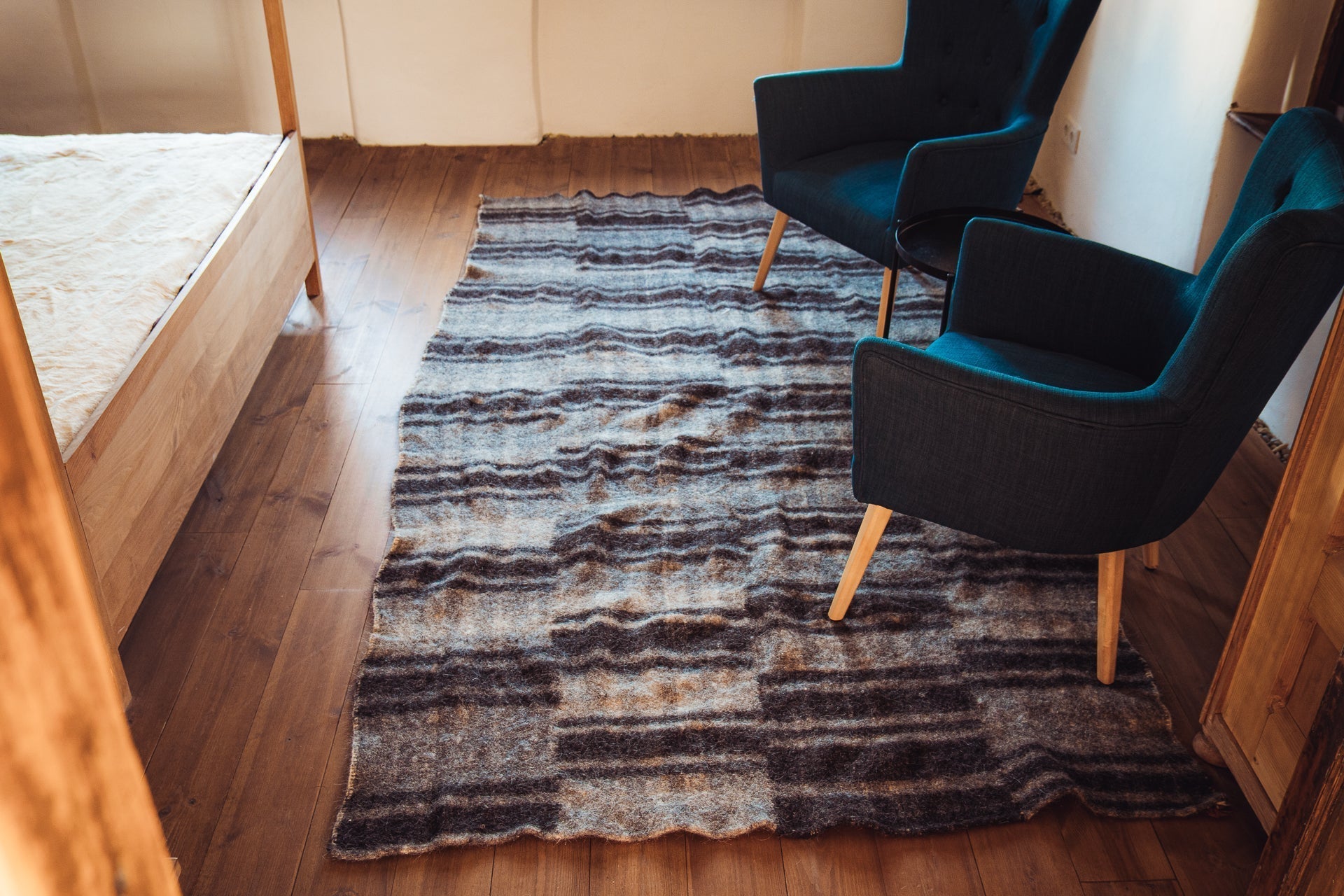 Antique handwoven Bulgarian wool rug, stripe design, 150x300 cm, in rustic room setting.