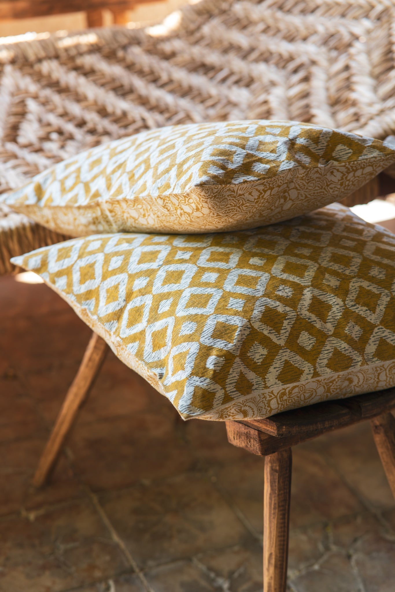 Hand printed linen pillow, artisan made in India, showcasing organic dye patterns on natural fabric.