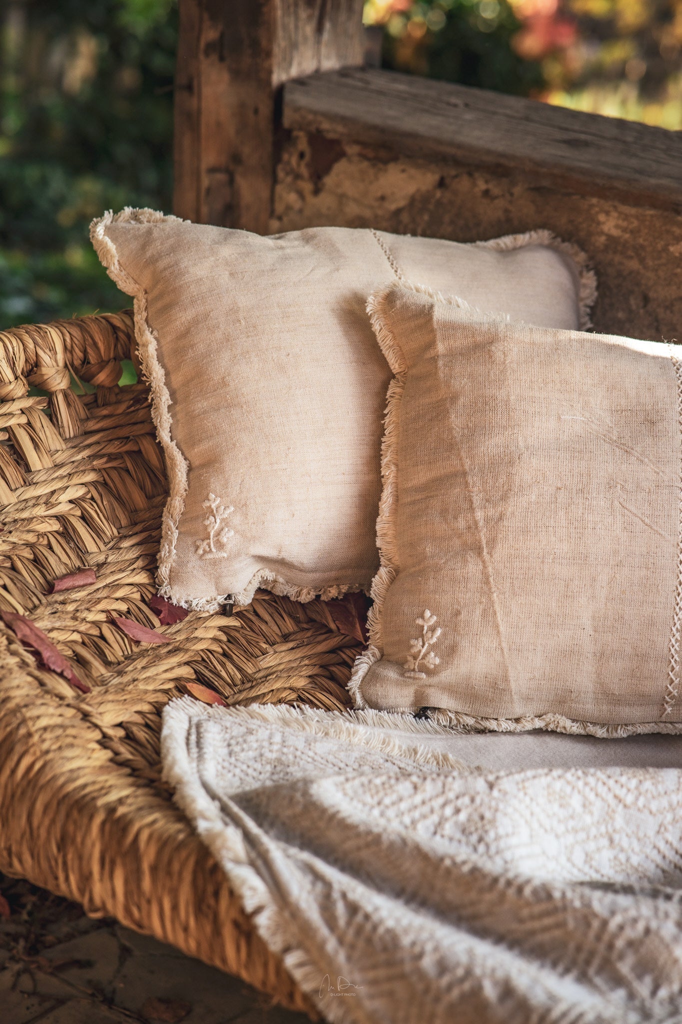 Handwoven antique Hungarian hemp pillow on rustic woven chair.