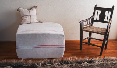 Rare antique Hungarian handwoven hemp ottoman with decorative strap, featuring latex padding and artisan craftsmanship.