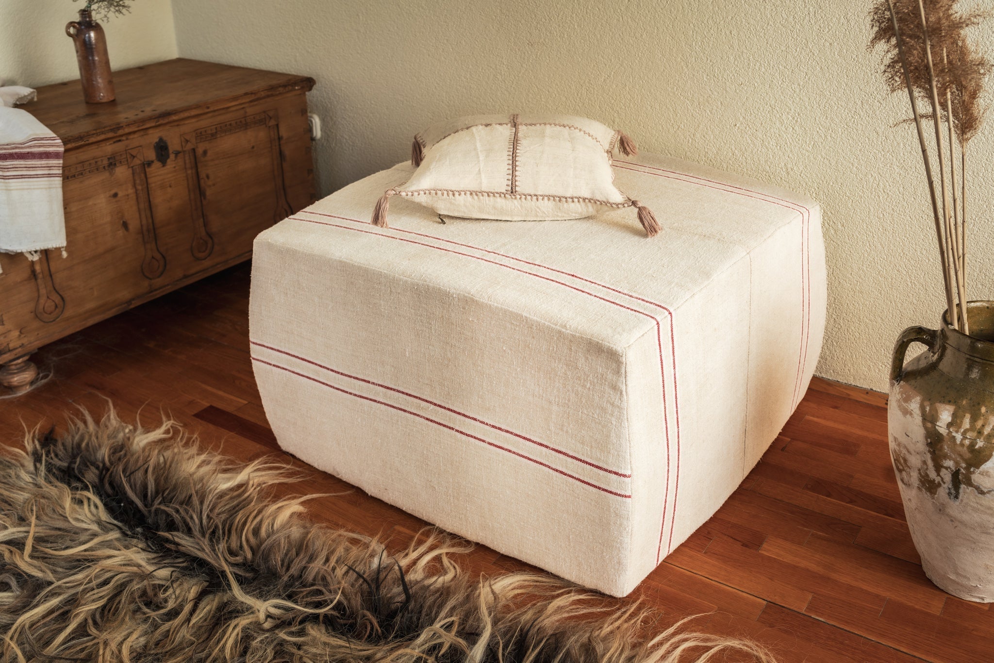Rare antique Hungarian handwoven hemp cloth ottoman with decorative strap.