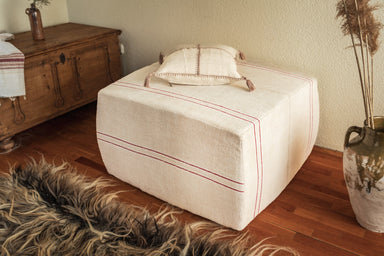 Rare antique Hungarian handwoven hemp cloth ottoman with decorative strap.