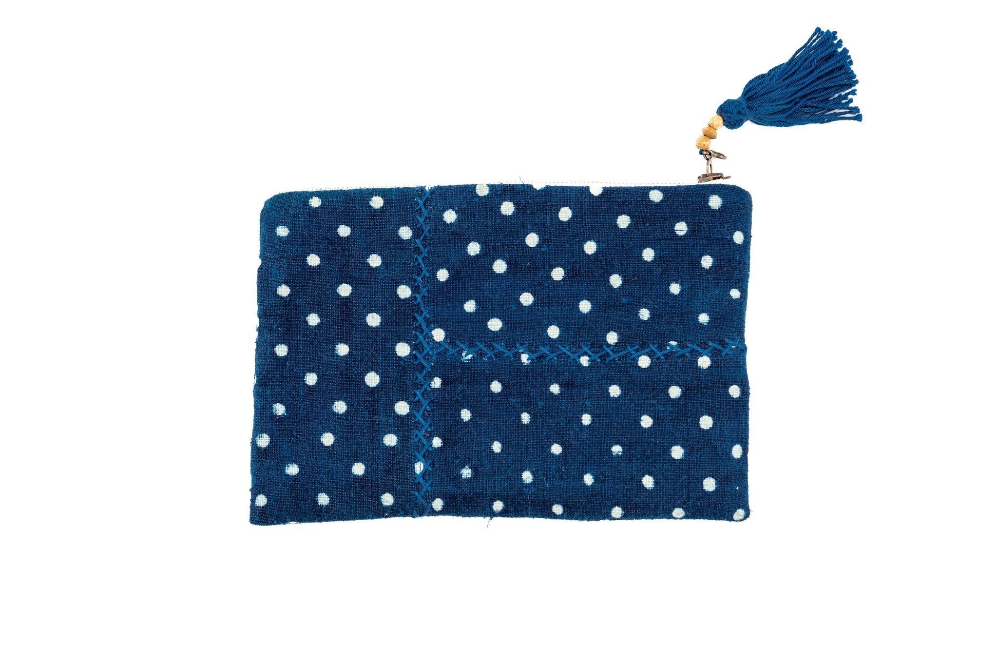 Handwoven antique wax resist painted indigo hemp bag with tassel and polka dot pattern.