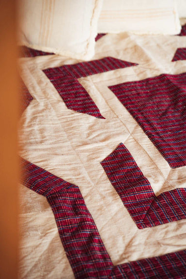 Organic handwoven hemp bed cover quilt with diamond appliqué pattern.