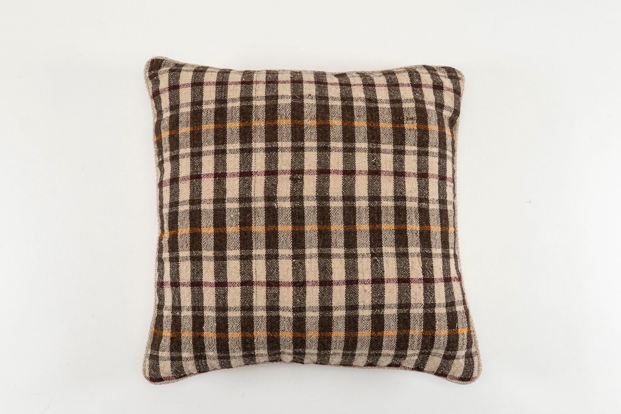 Handwoven antique Bulgarian woolen textile pillow with plaid design.