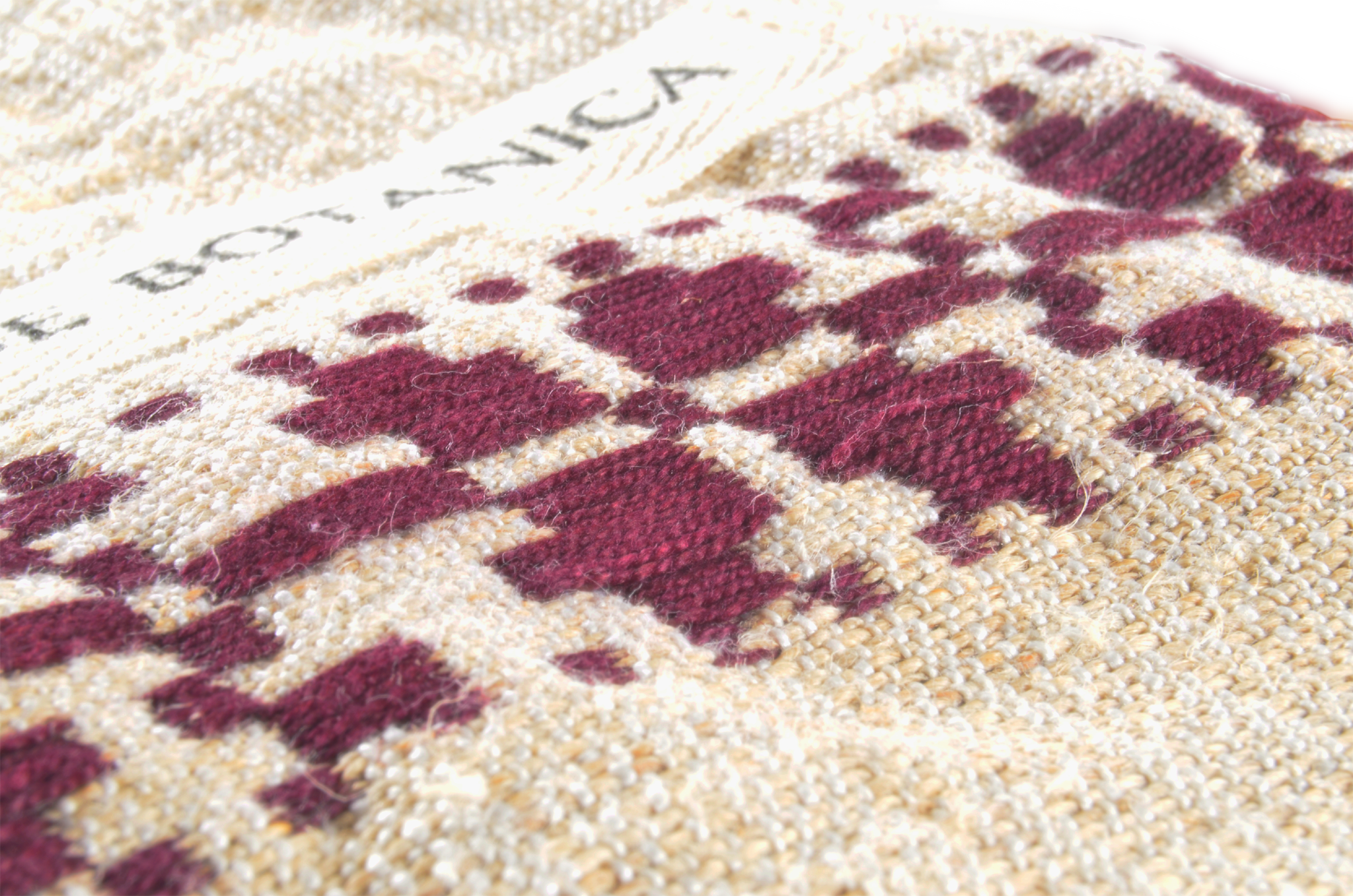 Handwoven antique hemp bag with red geometric embroidery pattern.