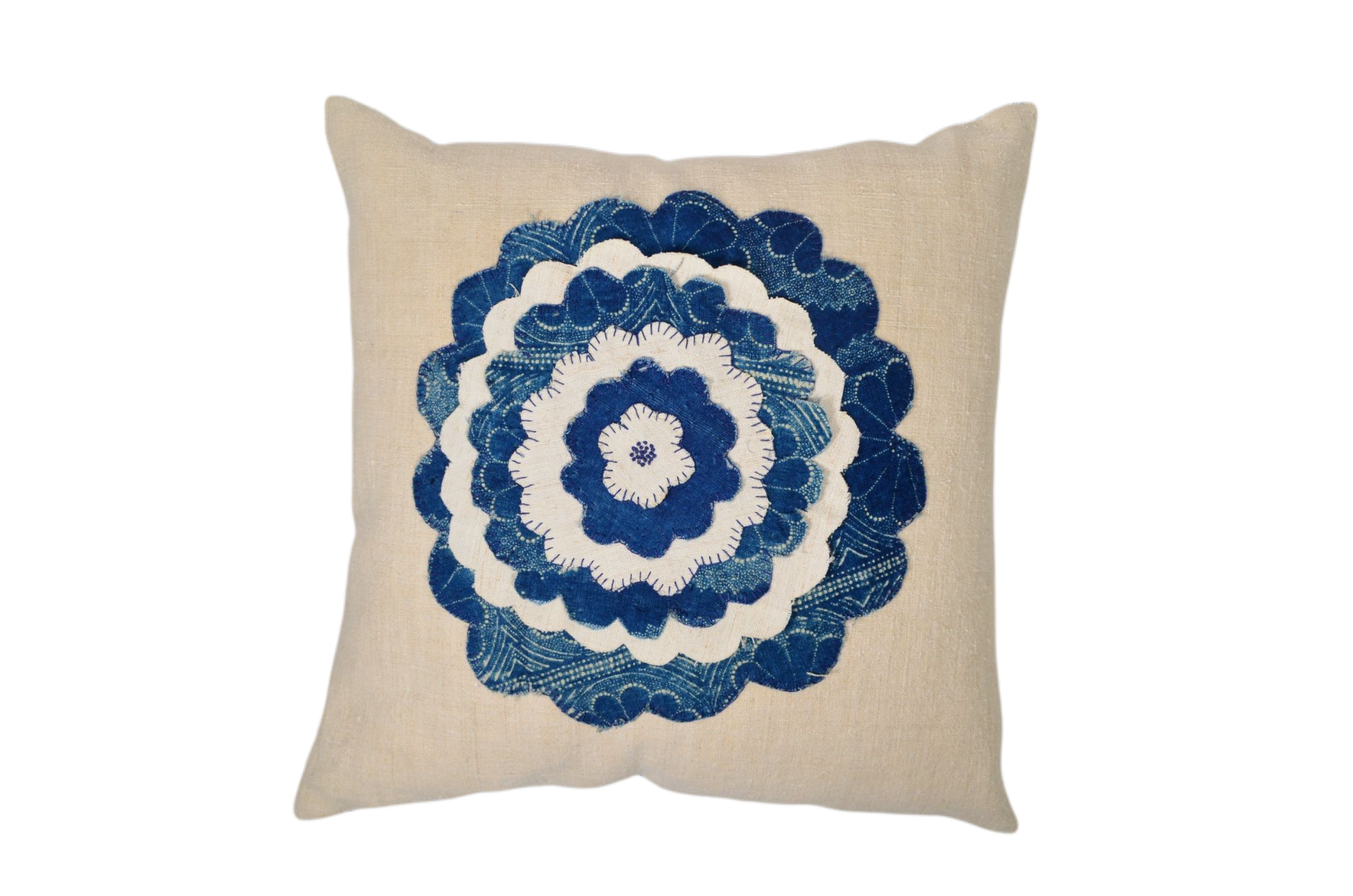 Antique handwoven decorative pillow with appliqué design.
