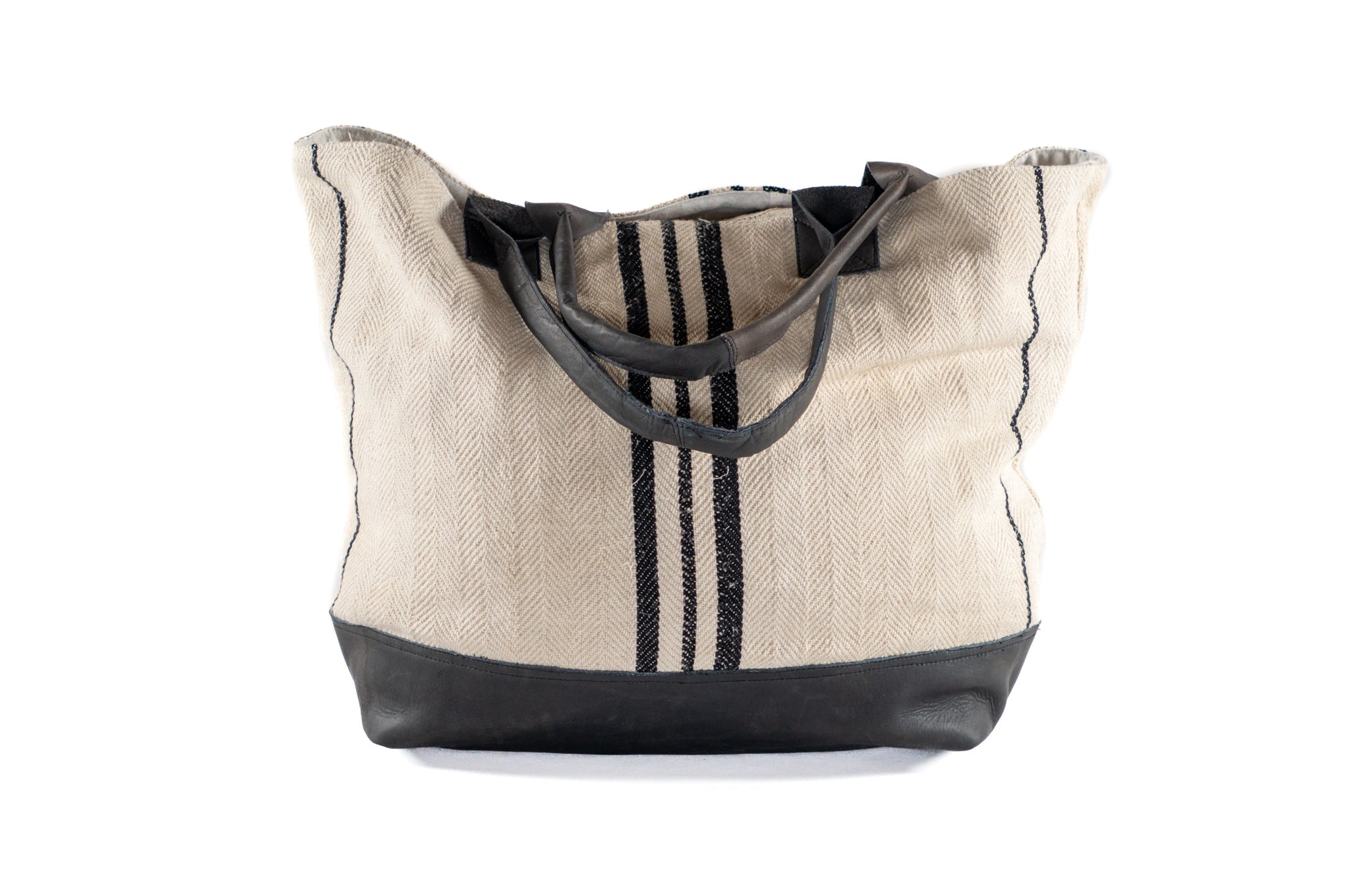 Handwoven antique Hungarian hemp bag with black stripes and leather details.