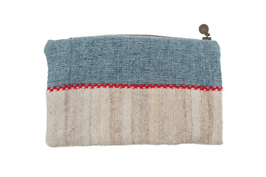 Handwoven wool bag with antique hemp lining, featuring natural dyes and a metal zipper.
