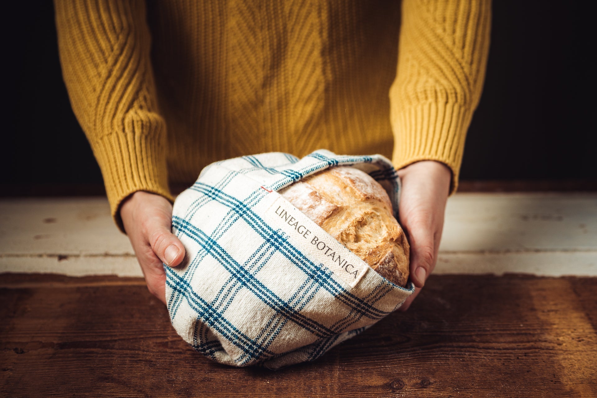 Antique handwoven Bulgarian cotton bag with bread, eco-friendly design.