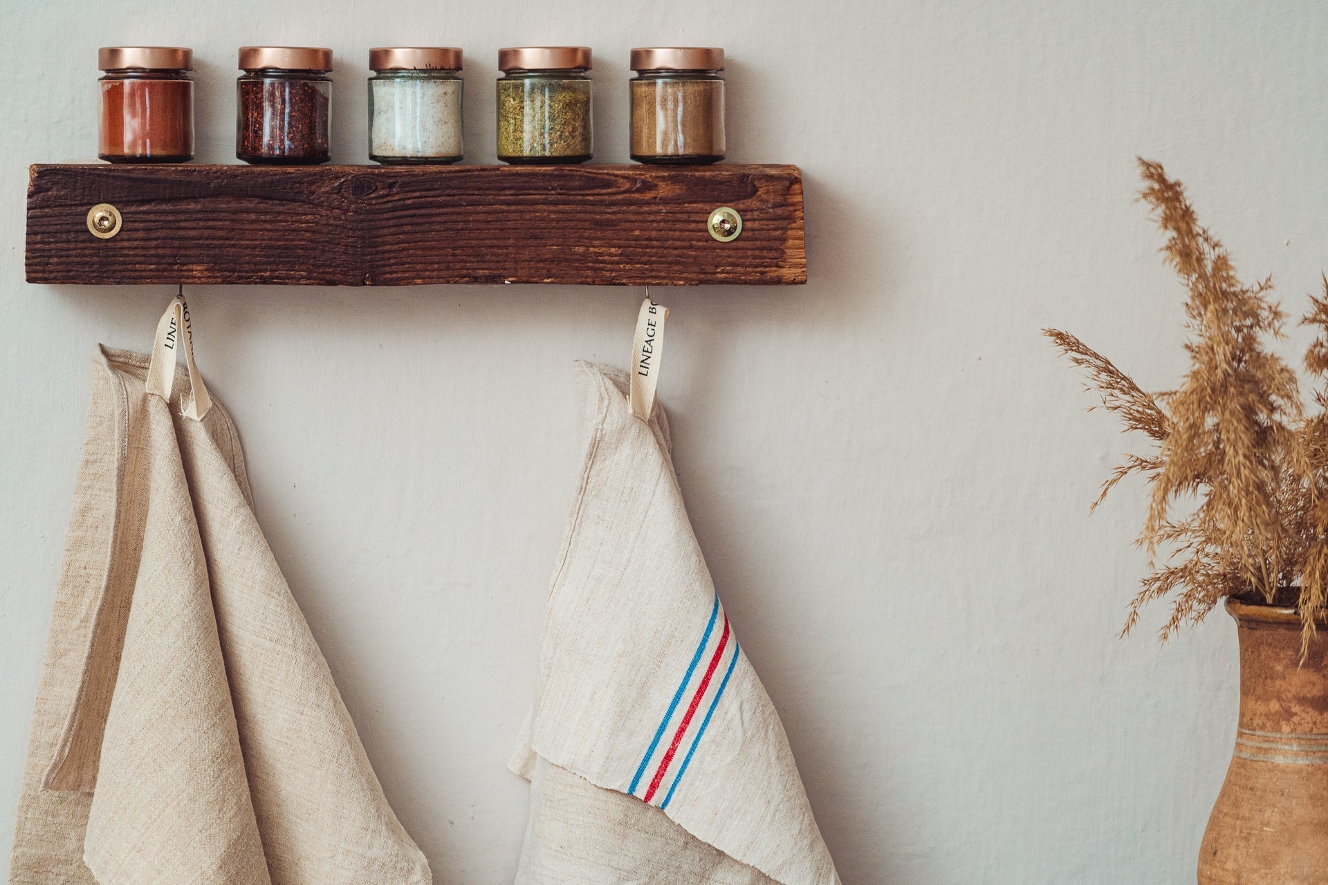 Handwoven antique Hungarian hemp towel hanging in kitchen setting.