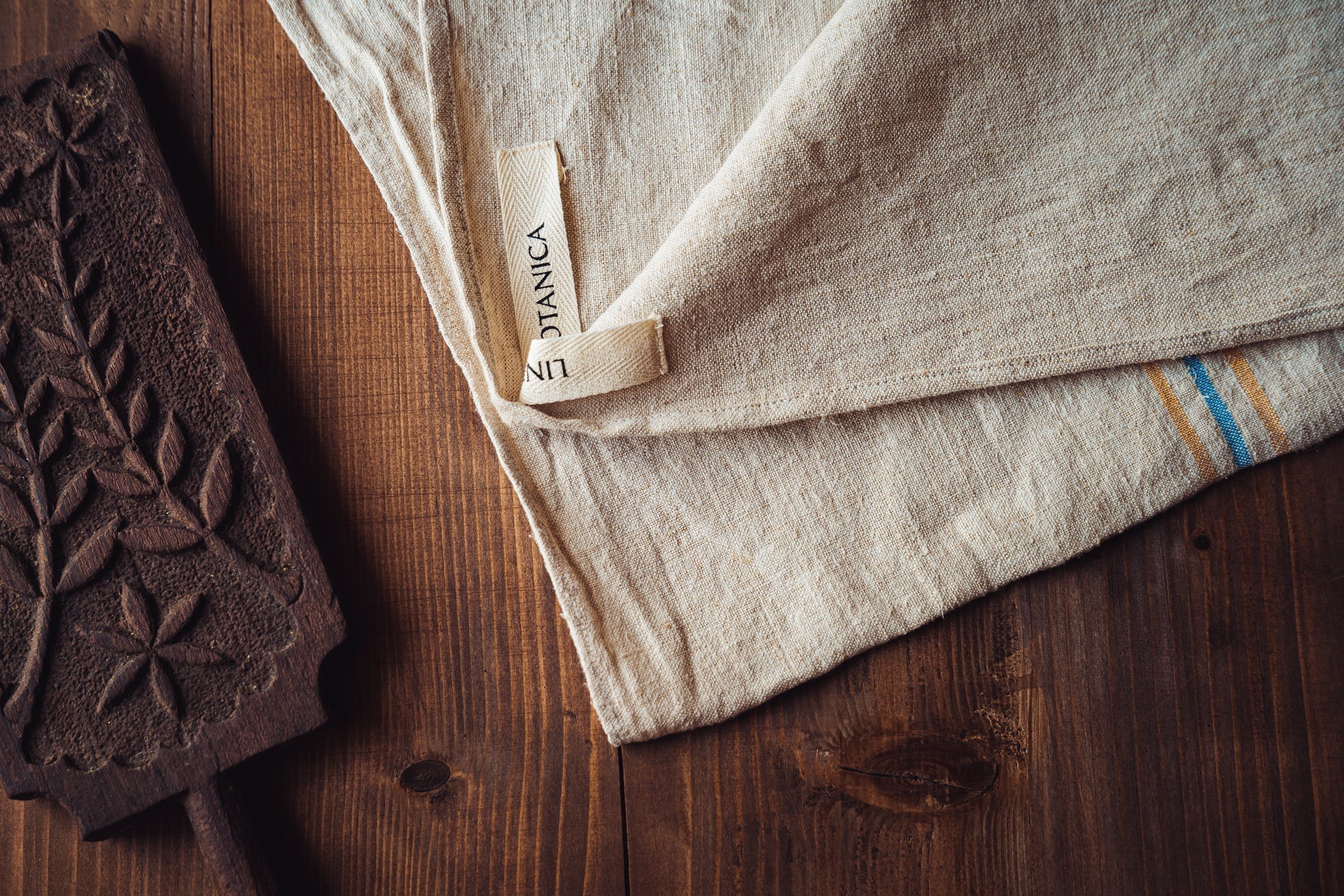 Handwoven antique Hungarian hemp towel on wooden surface.