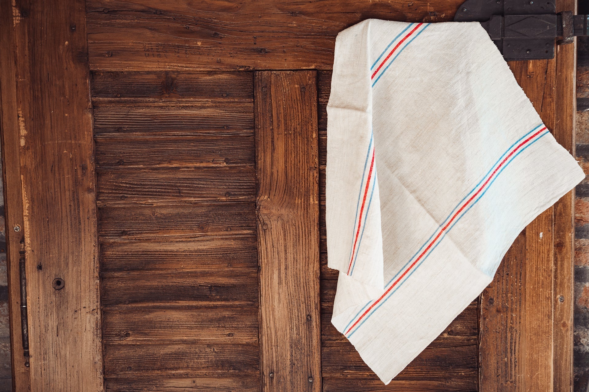 Handwoven antique Hungarian hemp towel on wooden background.