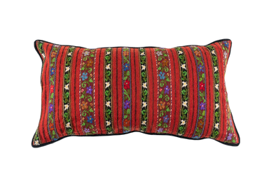 Handwoven Romanian artifact textile pillow with vibrant stripes and floral patterns.