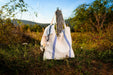 Antique grainsack bag made from handwoven hemp fabric, displayed outdoors against a wooden post.