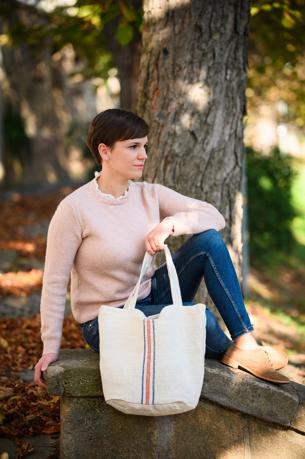 Antique grainsack bag from Hungary held by a person sitting outdoors.