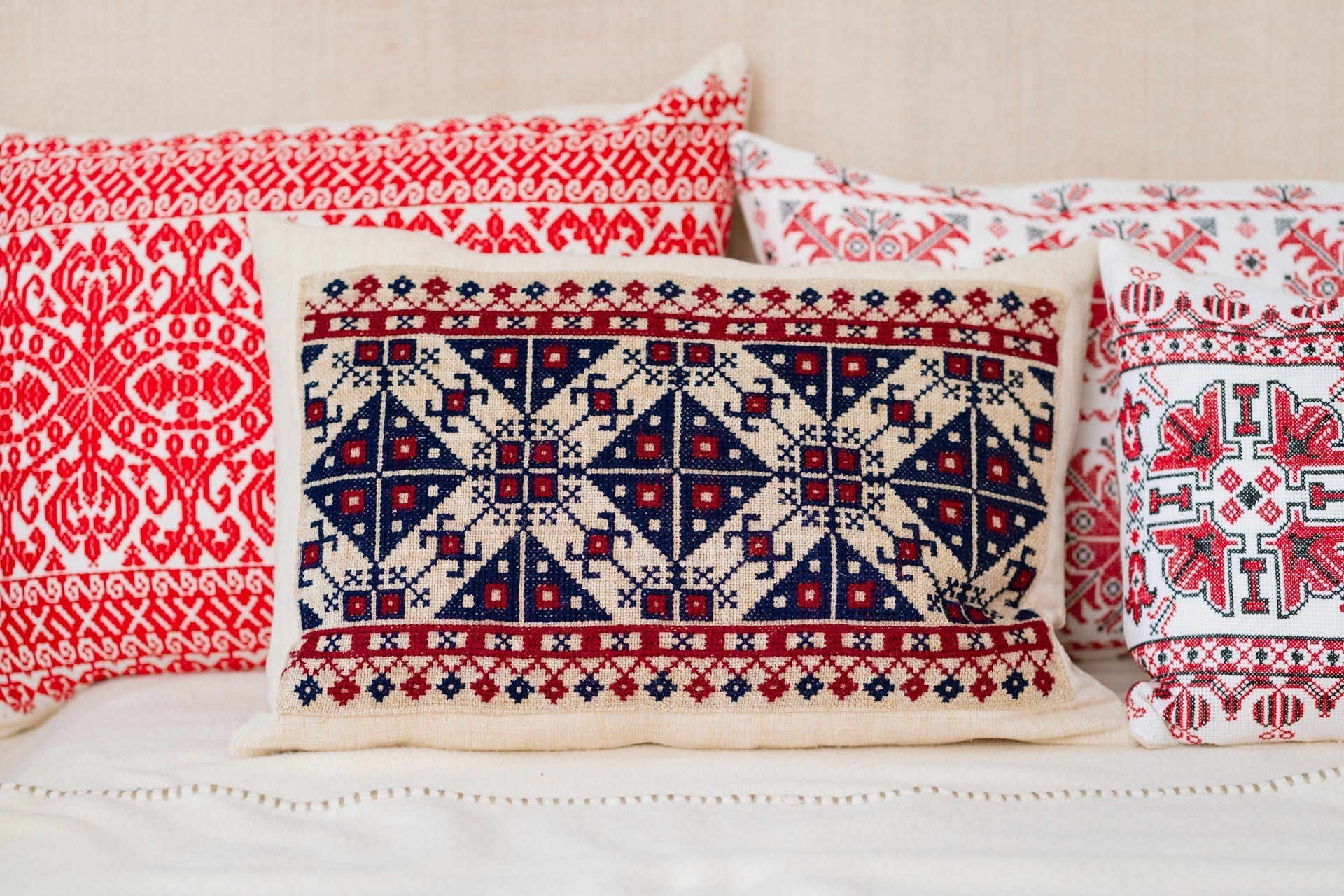 Embroidered handwoven antique Hungarian hemp pillow with geometric patterns.