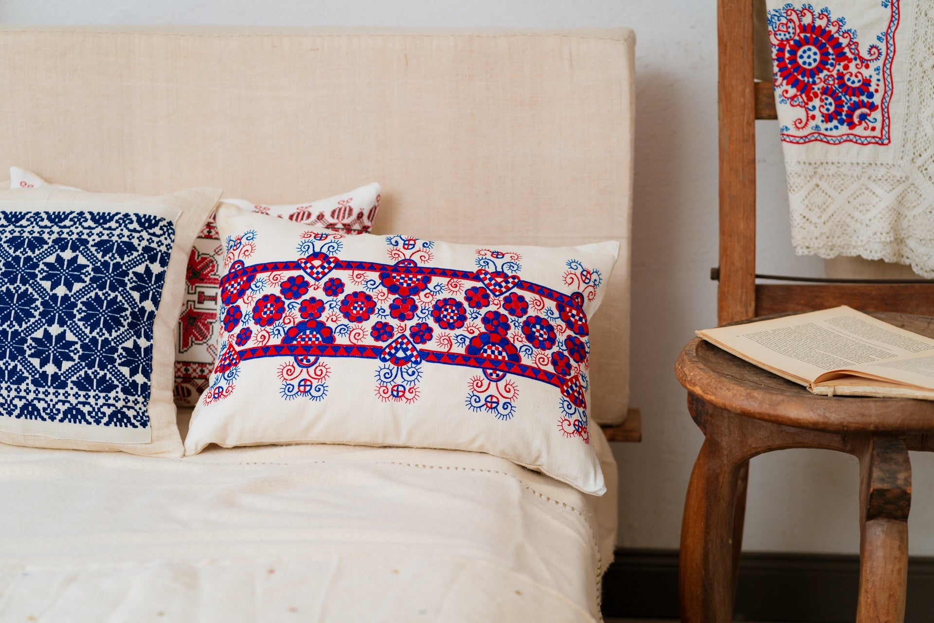 Embroidered handwoven antique Hungarian hemp pillow on a couch.