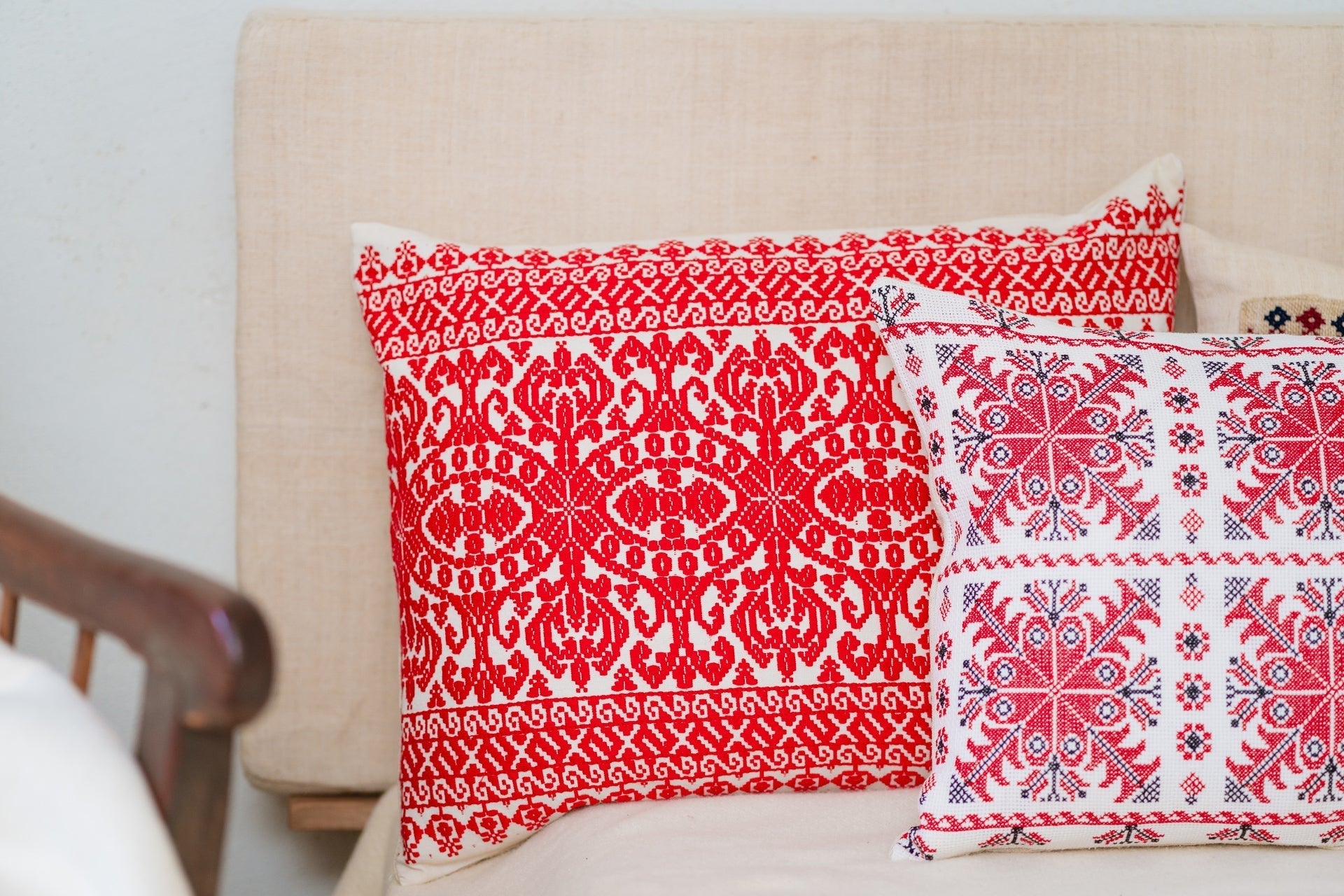 Embroidered handwoven antique Hungarian hemp pillow with red patterns.