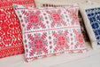 Embroidered handwoven antique Hungarian hemp pillow with red geometric patterns.