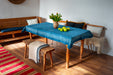 antique handwoven Hungarian hemp tablecloth in an indigo pattern on a wooden table