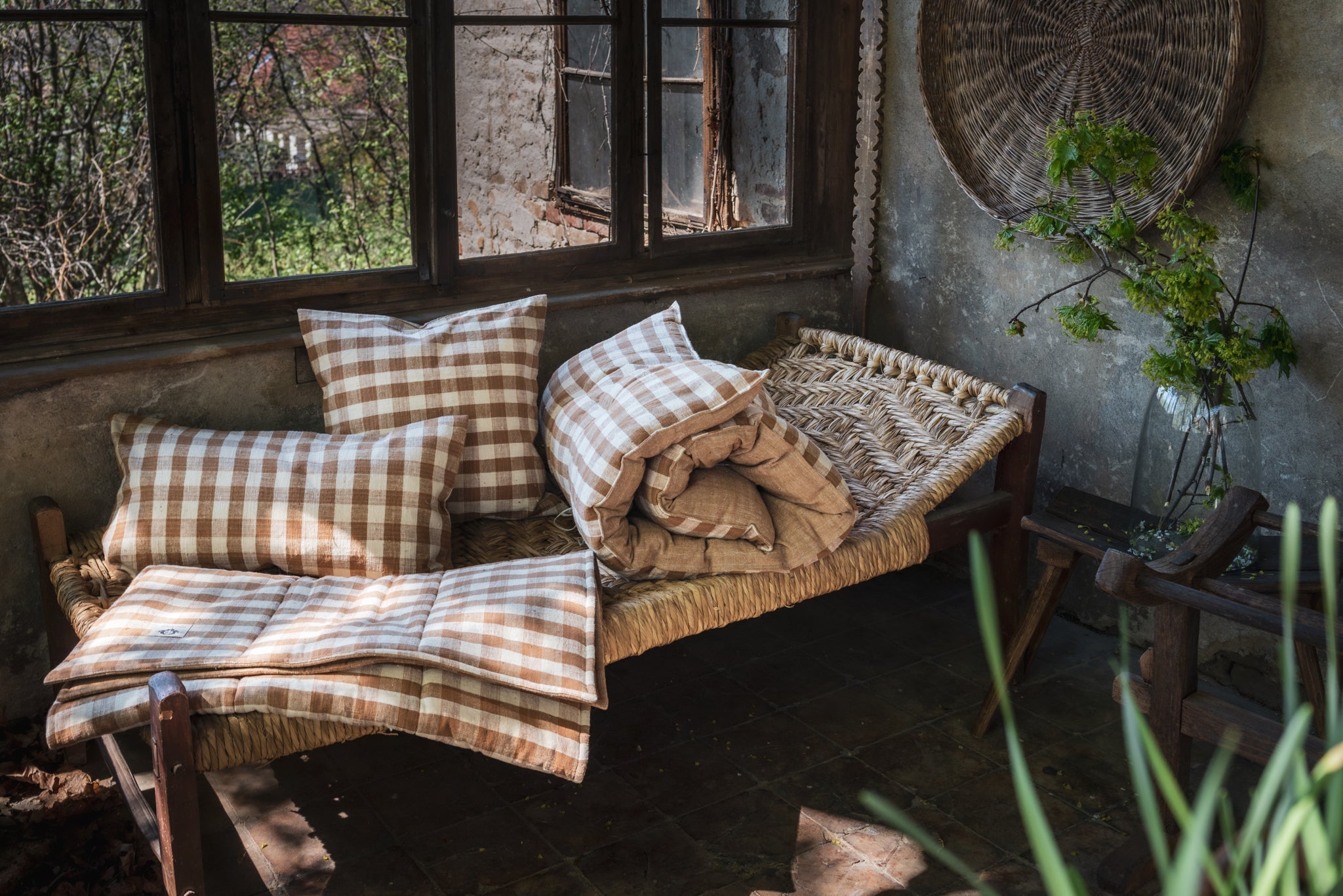 Handwoven cotton pillow P438 on rustic bench with natural plant dye.