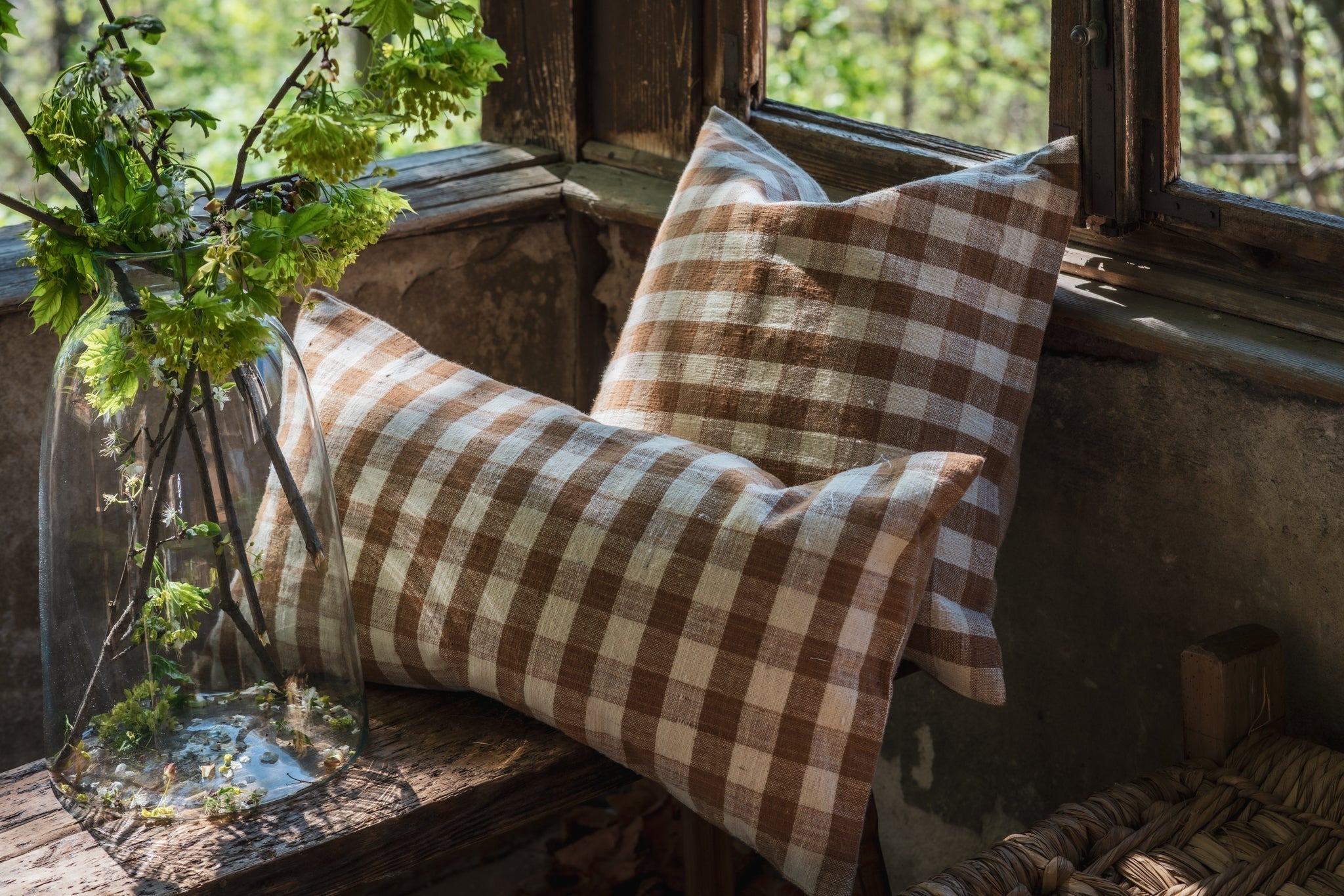 Handwoven cotton pillow with natural plant dye in rustic setting.