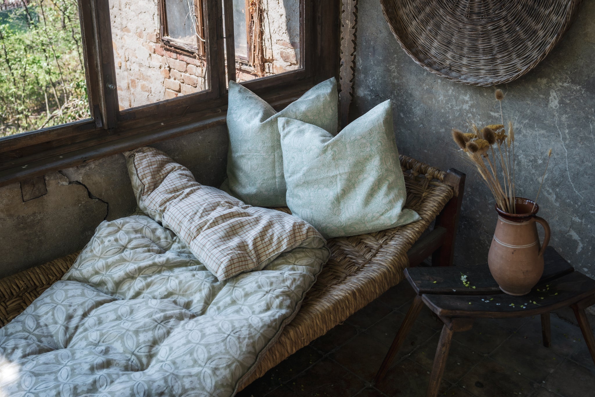 Hand block printed linen pillows in rustic room setting.