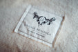 Organic eco cotton blanket label on a soft, natural fiber surface.