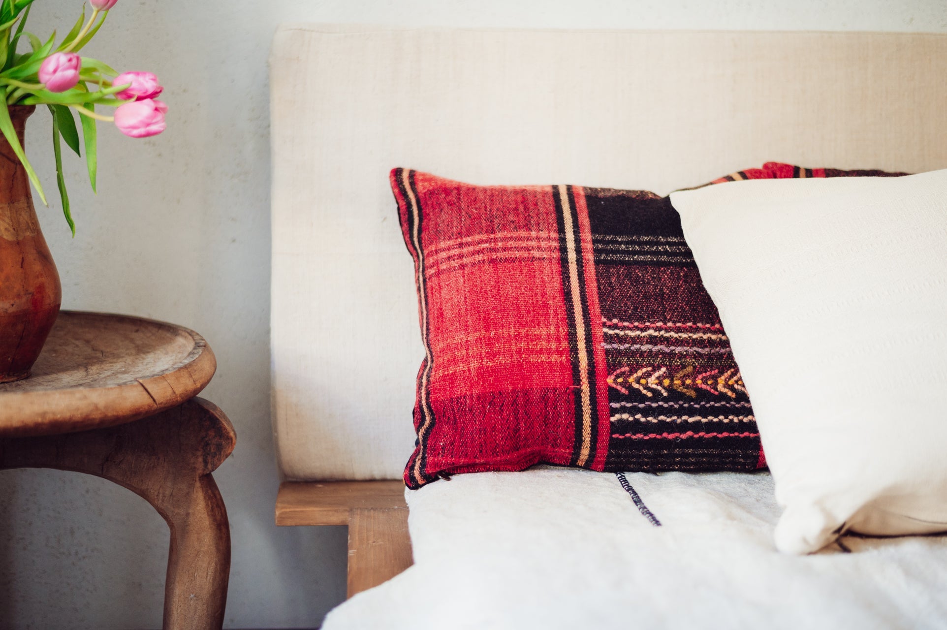 Handwoven Bulgarian textile pillow with wool details and cotton velvet back.