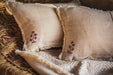 embroidered vintage Hungarian hemp pillow with traditional motifs on a rustic textile background