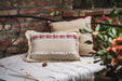 Handwoven antique Hungarian hemp pillow with carnation pattern and fringe.