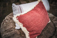 Handwoven antique Hungarian hemp pillow on rustic stone background, showcasing durable craftsmanship.