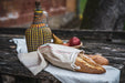 Handwoven antique and vintage hemp bread bags on rustic table.