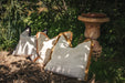 Handwoven antique Hungarian hemp pillows with cotton fringe outdoors.