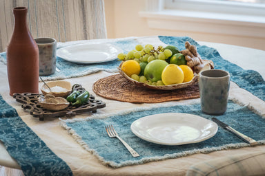 Handwoven Hungarian hemp table runner with natural and indigo pattern displayed on dining table.