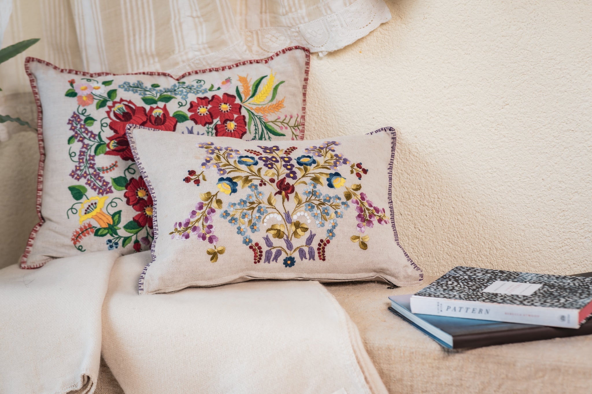 Embroidered handwoven antique Hungarian hemp pillow with floral design.