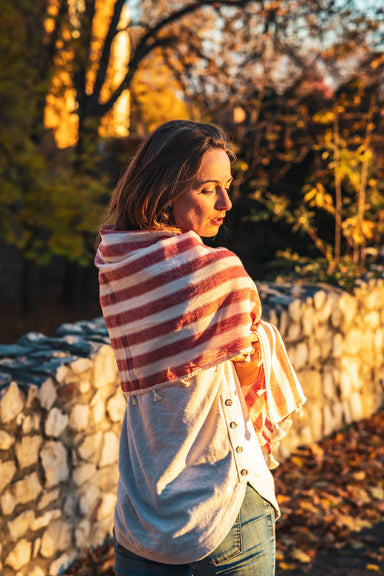 Organic cotton scarf handwoven in India with earthy tones and fringe detailing.