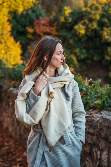 Handwoven silk and wool scarf with fringe, modeled outdoors.