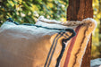 Embroidered antique handwoven Hungarian hemp pillow with indigo-dyed back and cotton fringe.