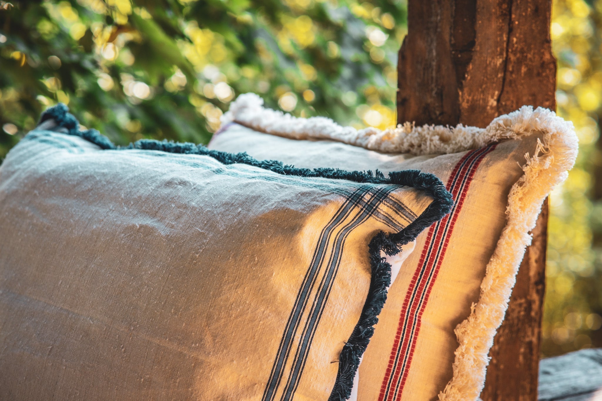 Embroidered antique handwoven Hungarian hemp pillow with indigo-dyed back and cotton fringe.