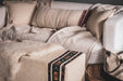 Embroidered antique and vintage Hungarian hemp pillows on a cozy rustic sofa setting.