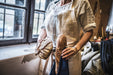 Handwoven antique and vintage hemp bread bags with fresh bread in kitchen.