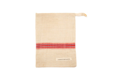 Handwoven antique and vintage hemp bread bag with red stripe detail.