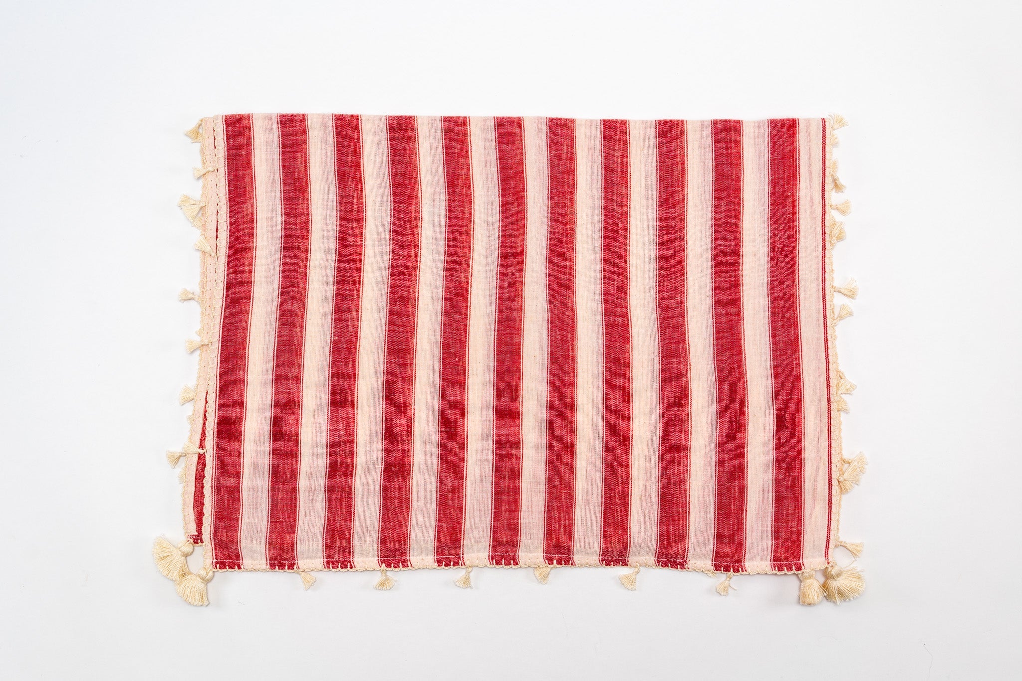 Handwoven organic cotton scarf from India with red and cream stripes and fringed edges.