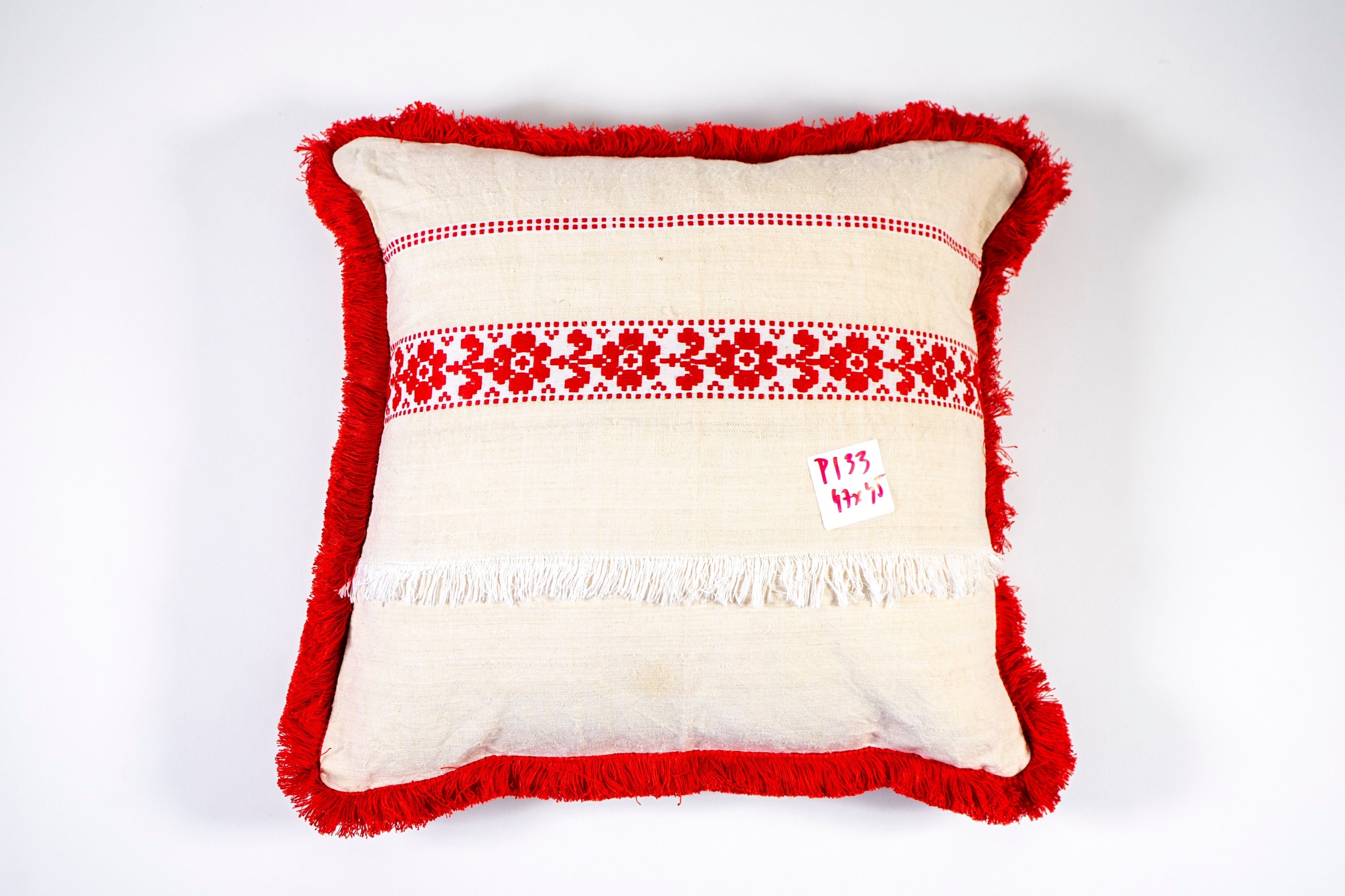 Embroidered antique handwoven Hungarian hemp pillow with red accents and intricate design.