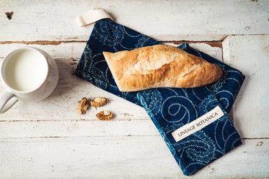 Handwoven antique hemp baguette bag with indigo dye and baguette bread.