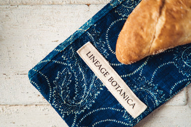 Handwoven antique baguette bag in indigo blue with bread loaf.